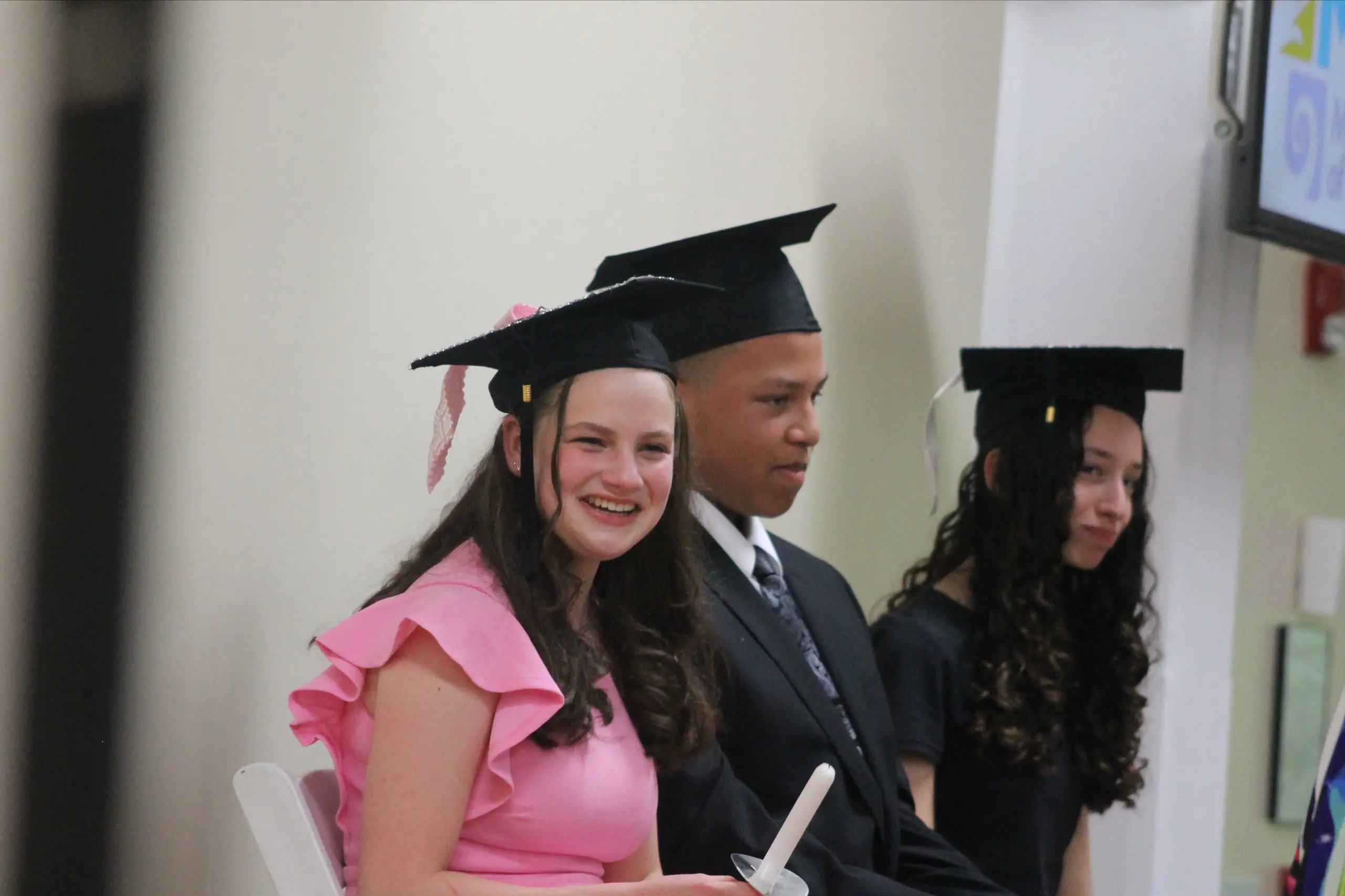 MSNV graduates in caps and gowns celebrating at a graduation ceremony.