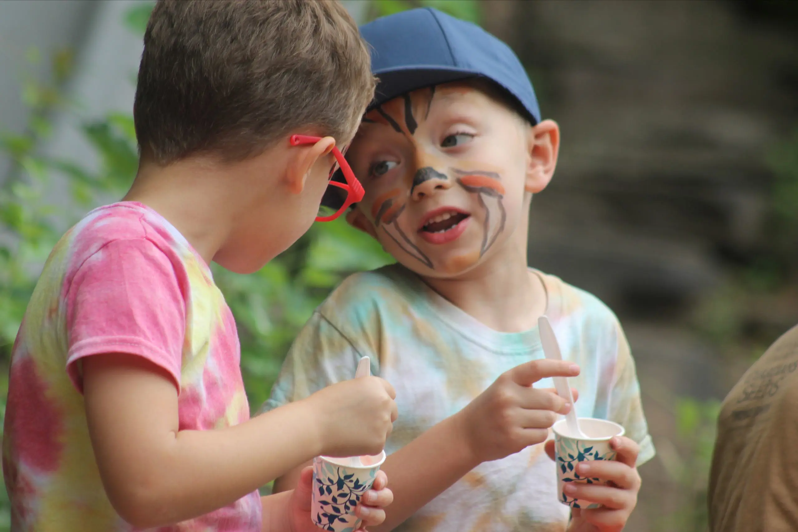 Two MSNV Camp students enjoying snow cones outdoors on a summer day.