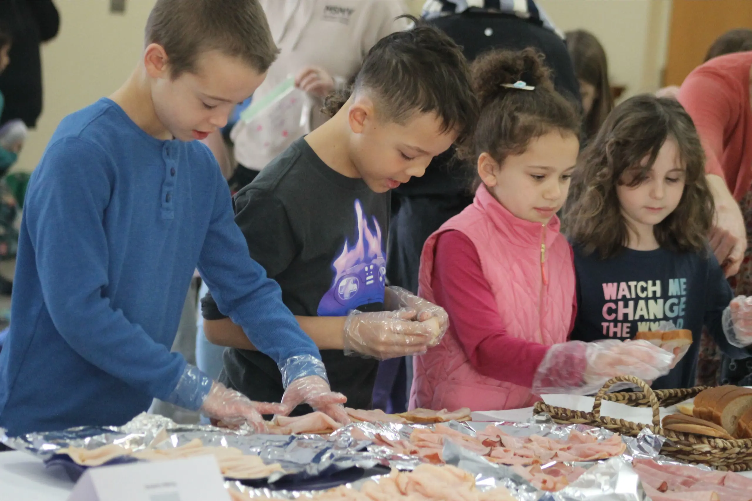 A group of MSNV elementary students collaborating on community support together at a table.