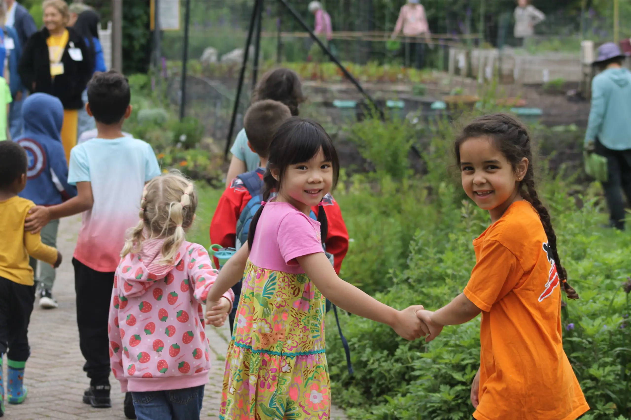 A group of MSNV primary students walking together outdoors on a school day.
