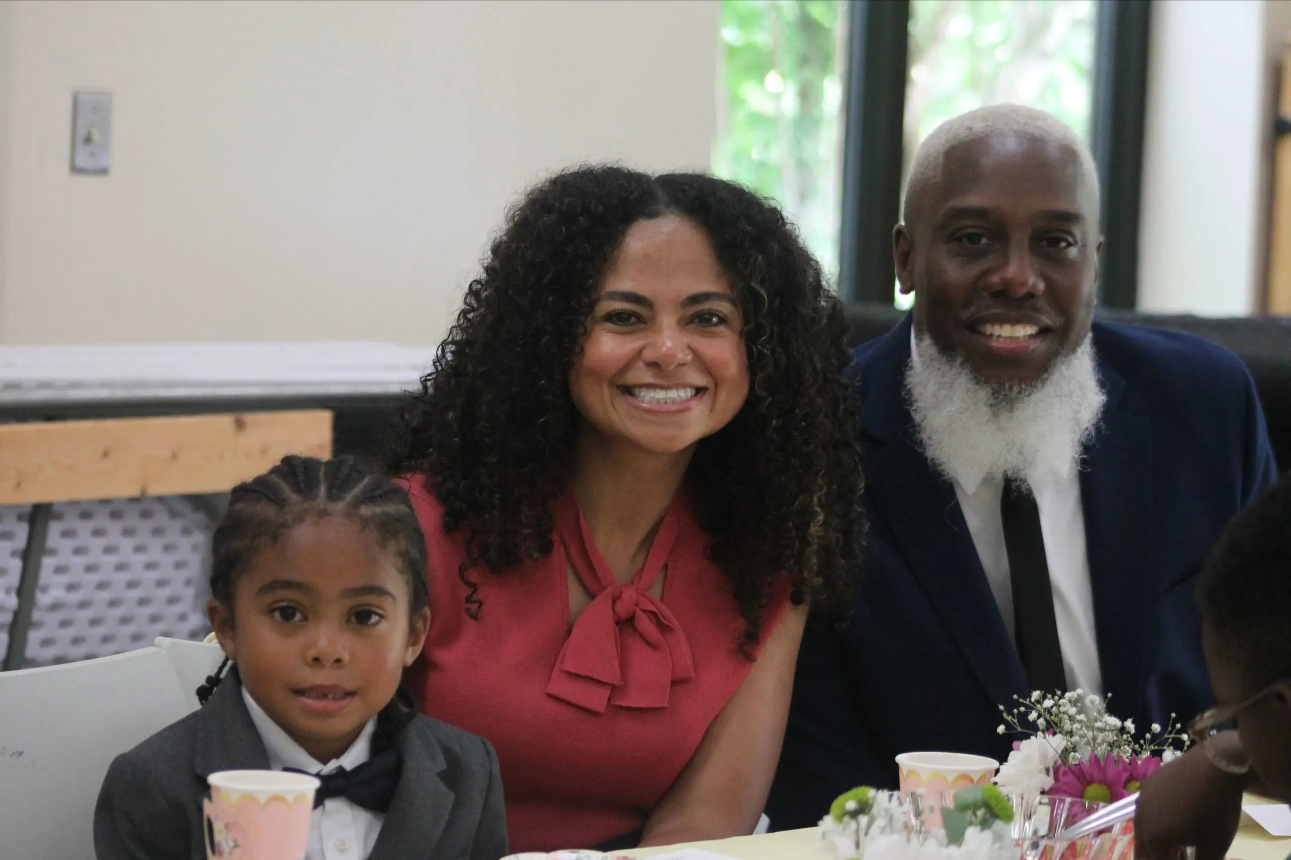 An MSNV family — smiling together at a school community event.
