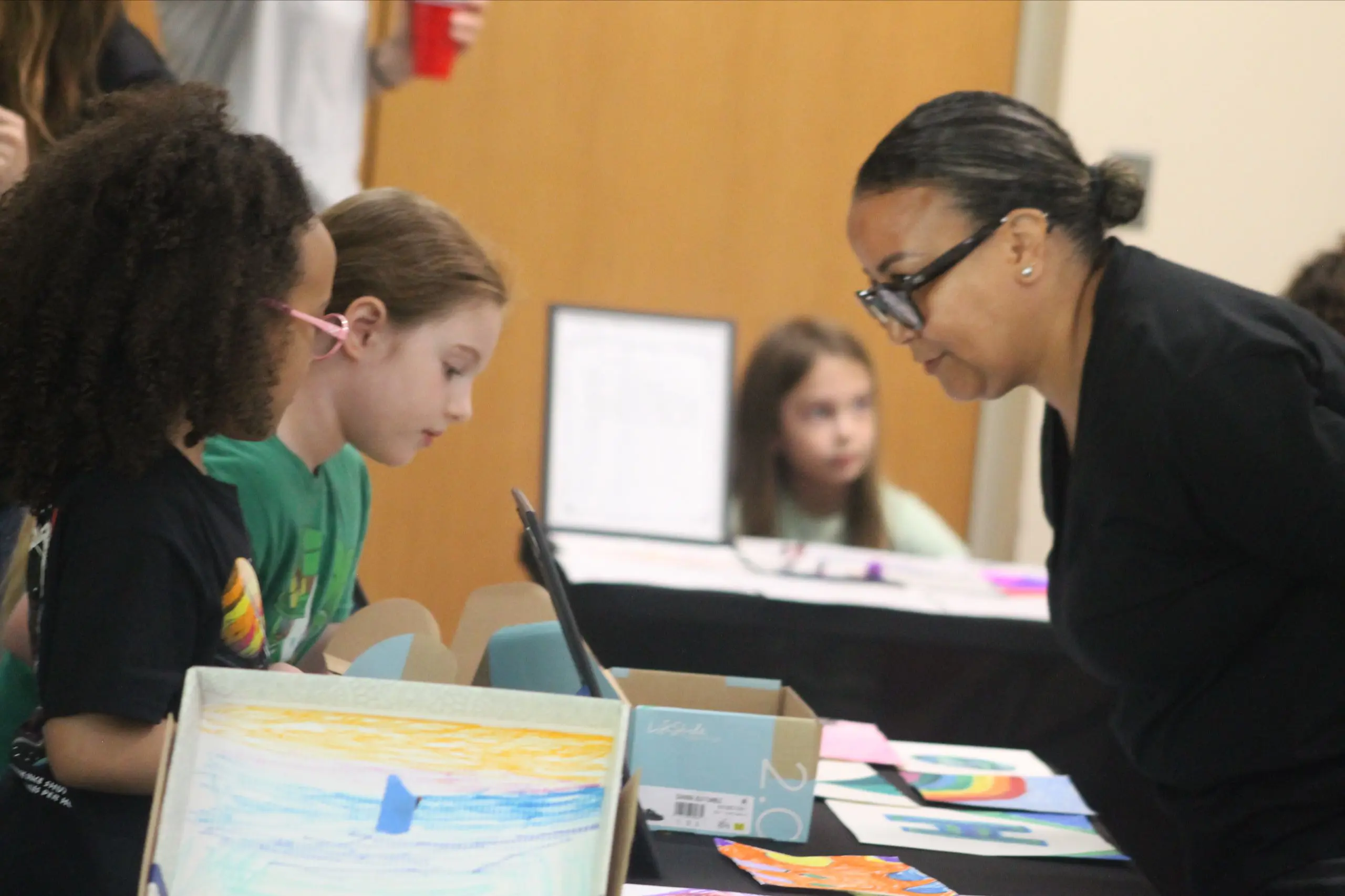 An MSNV teacher supporting students working during a classroom activity.