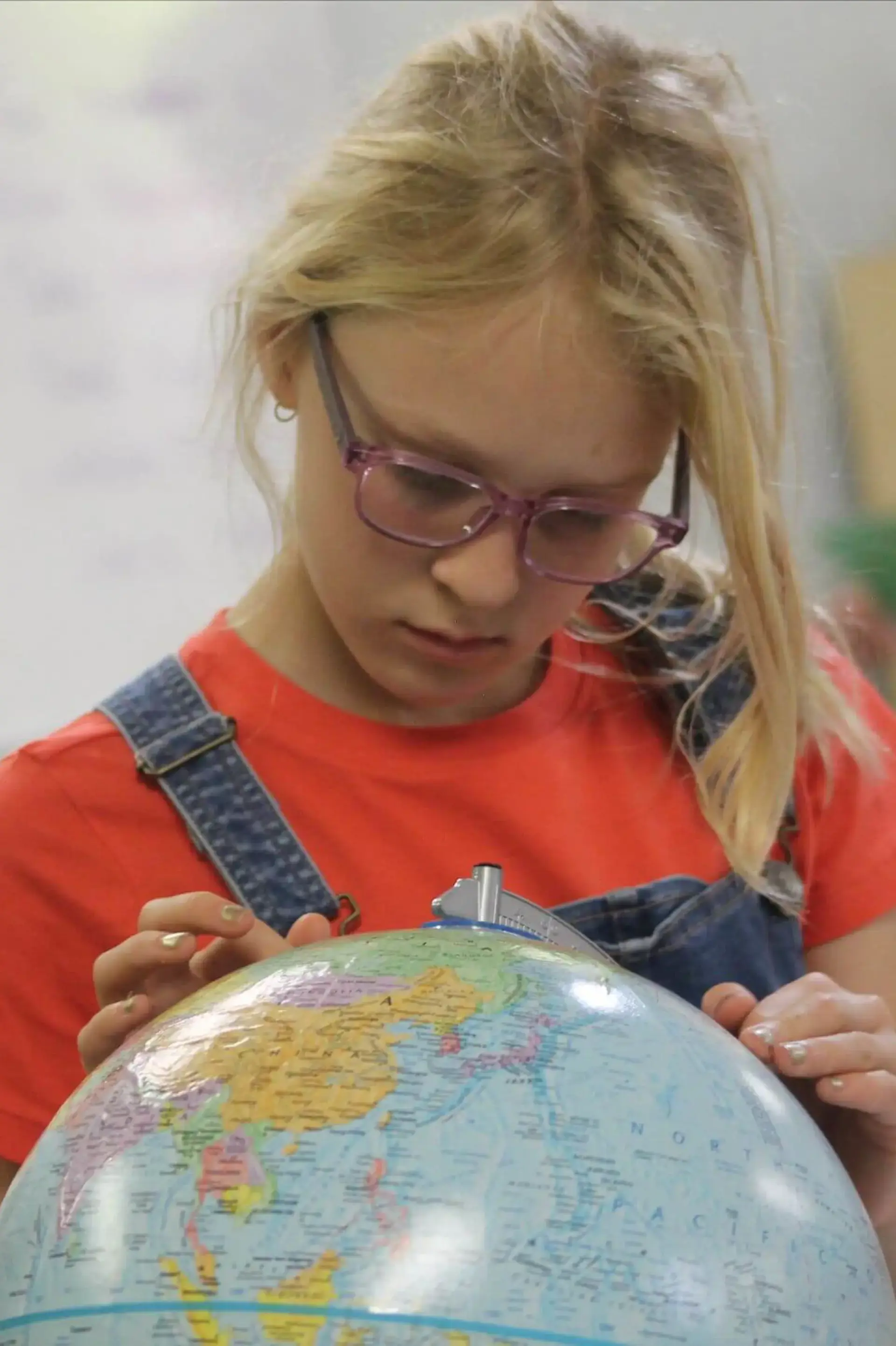 Student examining globe