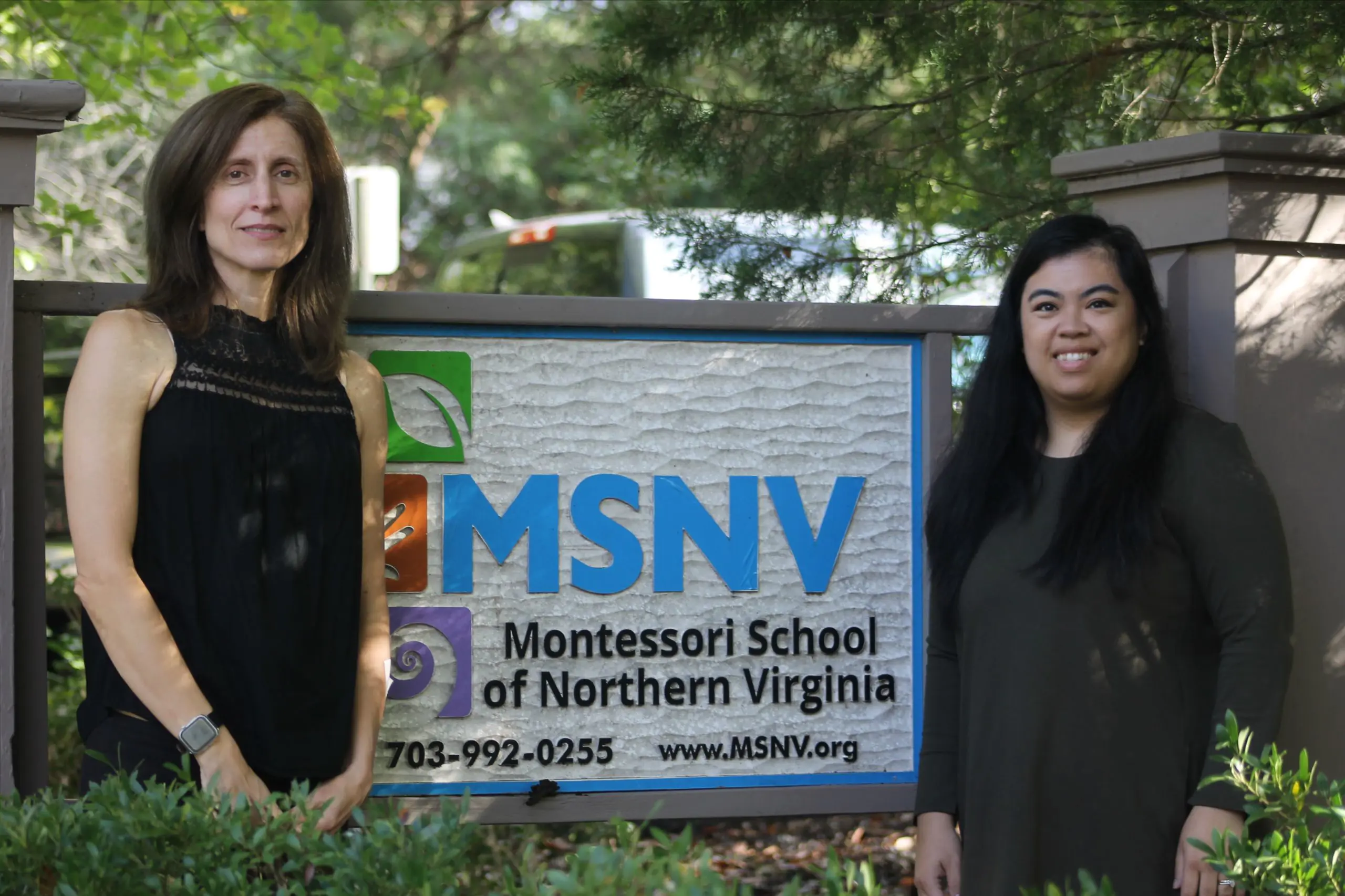 MSNV staff standing in front of the Montessori School of Northern Virginia sign.